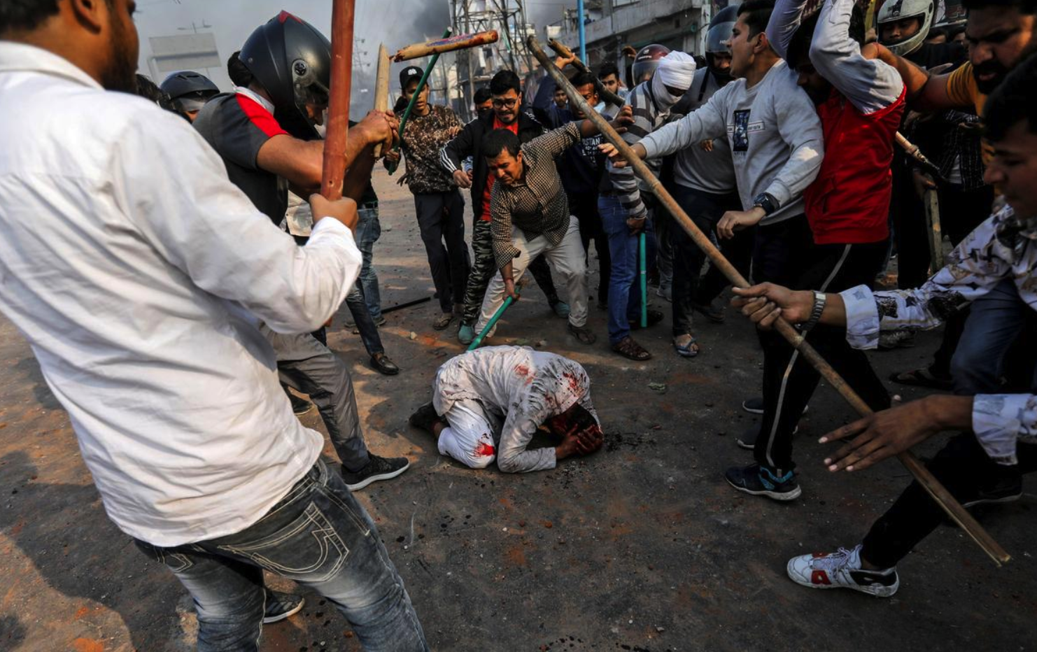 A group of men chanting pro-Hindu slogans, beat Mohammad Zubair, 37, who is Muslim, during protests sparked by a new citizenship law in New Delhi, India, February 24, 2020. REUTERS/Danish Siddiqui/File photo